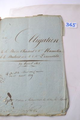 an old document with writing on it sitting on a table
