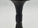 an image of a black metal pedestal with a bird on it