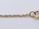 a close up of a gold chain with a heart on it