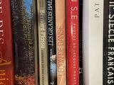 many books that are on a shelf in the room