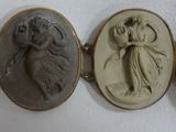 four oval cameos of women and a man with a bird