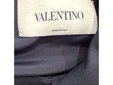 a label on a black jacket that says valentinino made in italy