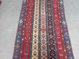 a red, blue and yellow rug with a pattern on it