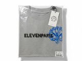 a grey t - shirt with a blue flower on the front