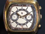 a close up of a watch on a black surface