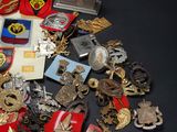 a pile of badges and other items on a table