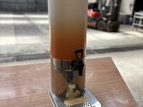 un distributeur de boissons posé sur une table devant un bâtiment