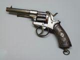 a close up of a gun on a table with a white background
