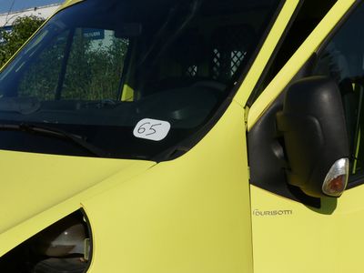 a yellow van with a sticker on the side of it