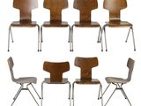 set of six chairs with a wooden seat and metal legs
