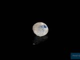 a white diamond on a black surface with a reflection