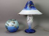 a lamp that is next to a ball on a table