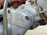 a close up of a motor bike with a red handlebar