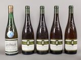 six bottles of wine are lined up on a table