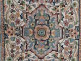 a close up of a rug on a wooden floor