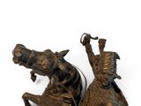 bronze statue of a man on a horse and a woman on a horse