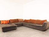 an image of a living room with a couch and ottoman