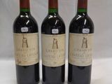 three bottles of wine sitting on top of a table next to each other