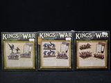 three cards with pictures of kings and warriors on them sitting on a table