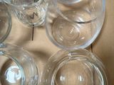 six empty glasses in a box on a table