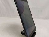 a close up of a tablet on a stand on a white surface