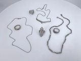 a white plate with a bunch of jewelry on it