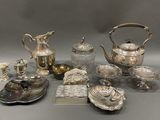 many different silver items on a table together