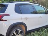 a white car that is parked in the grass