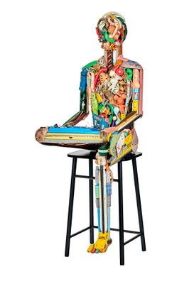 a sculpture of a human body sitting on a stool