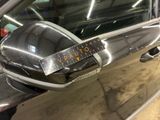 a close up of a car door handle with a sticker on it