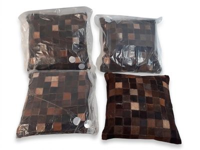 two pillows and a pillow are wrapped in plastic bags on a white surface
