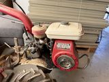 a small engine that is sitting in a garage