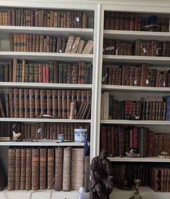 many old books on the shelves in this room