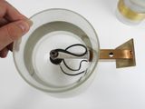 a person holding a pair of scissors in a cup