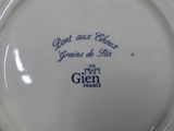 a white plate with blue writing on it on a table