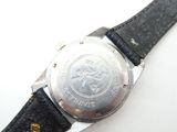 a close up of a watch on a white surface