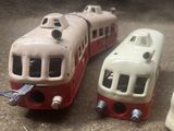 two toy trains sitting next to each other on the floor
