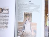 an open book with a picture of a woman in a white dress