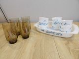 four glasses and a tray on the table next to each other