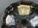 a silver plate with a floral design on it