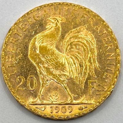 a close up of a gold coin with a rooster on it