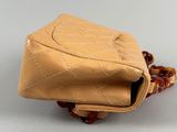 beige leather purse with chain strap and handle on white surface