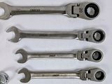 a lot of wrenches that are laying out on the table