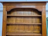 a wooden bookcase with a book on top of it