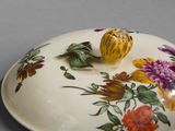 a plate with a flower design on it on a table