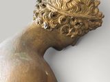 statue of a young man with curly hair and no shirt on