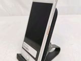 a cell phone that is on a stand on a table