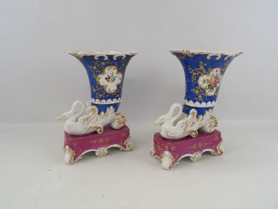 two vases that have swan designs on them