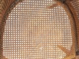 a close up of a wicker chair with a white background