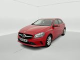 a red mercedes cla parked in a white room
